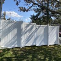 white vinyl fence with picket eavestrough