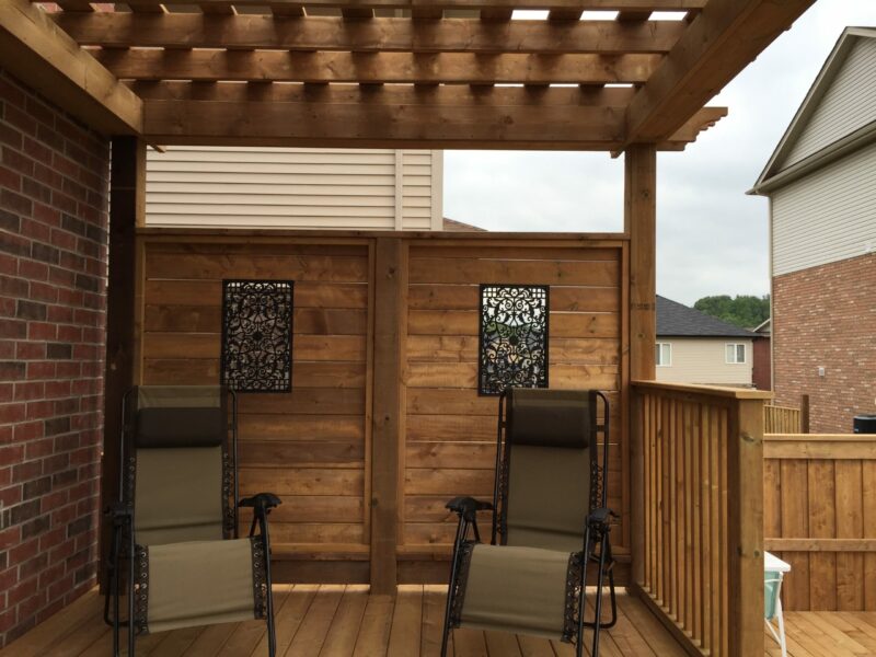 Backyard Wood Deck With Pergola And Iron Inserts