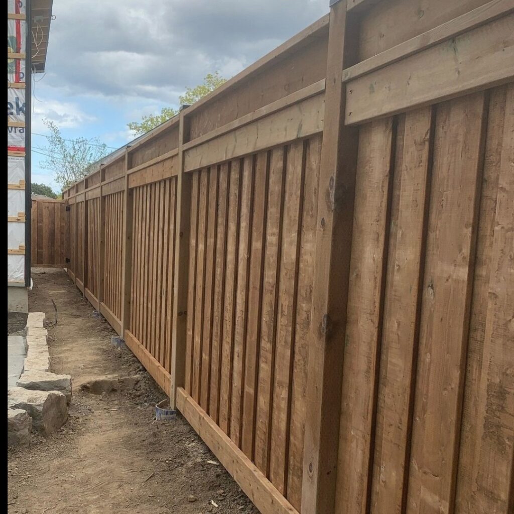 Backyard side view of vertical wood fence 6x6