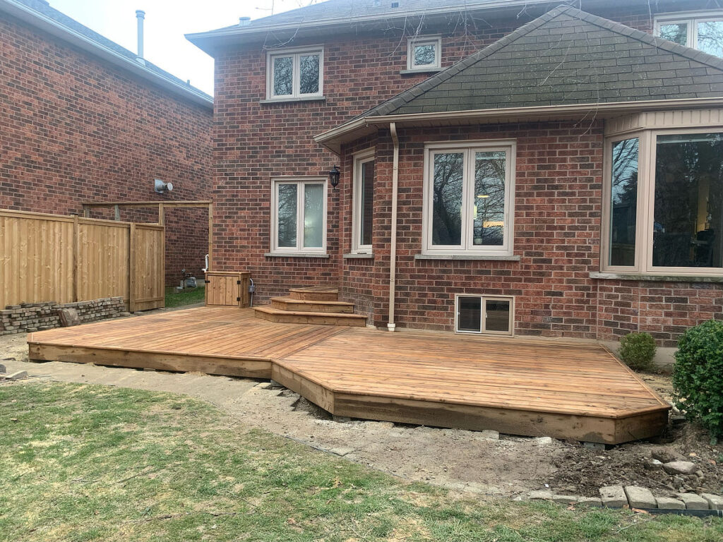 a brick house with a wooden deck with steps