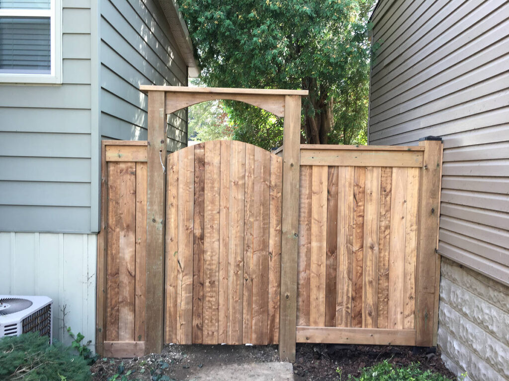 Wood arched gate attached between 2 houses