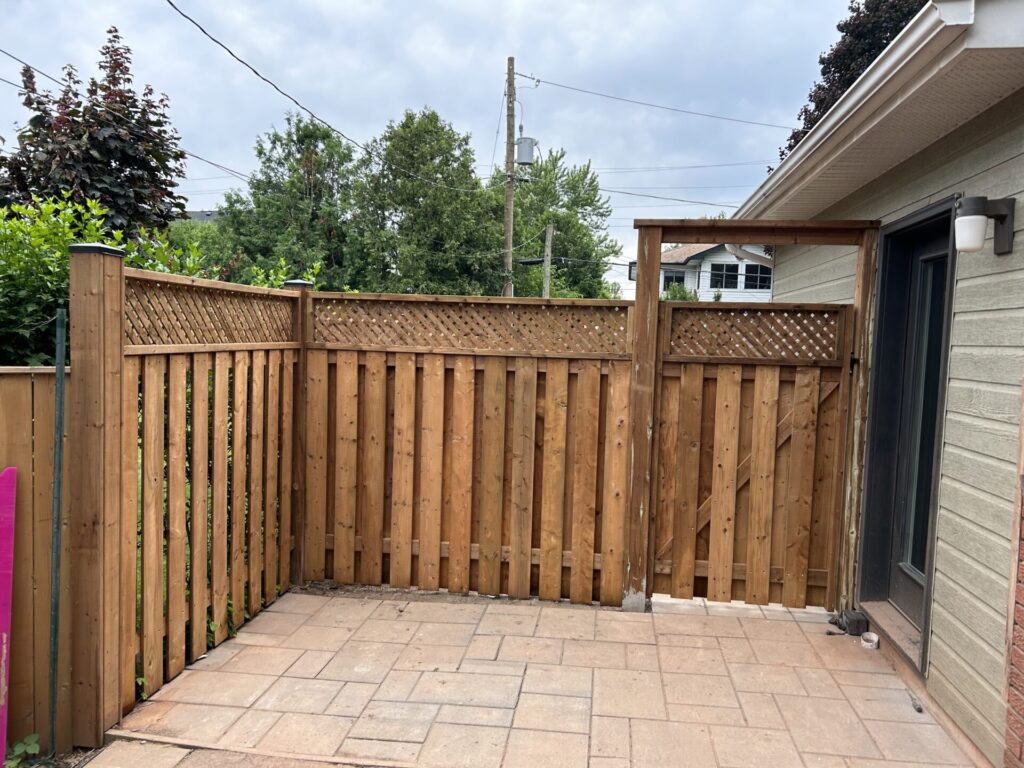 backyard good neighbour fence with gate attached to side of the house