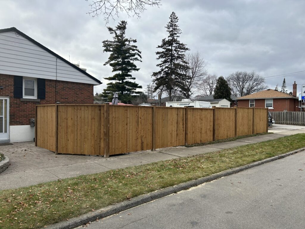 vertical single board privacy fence in cement tile ground