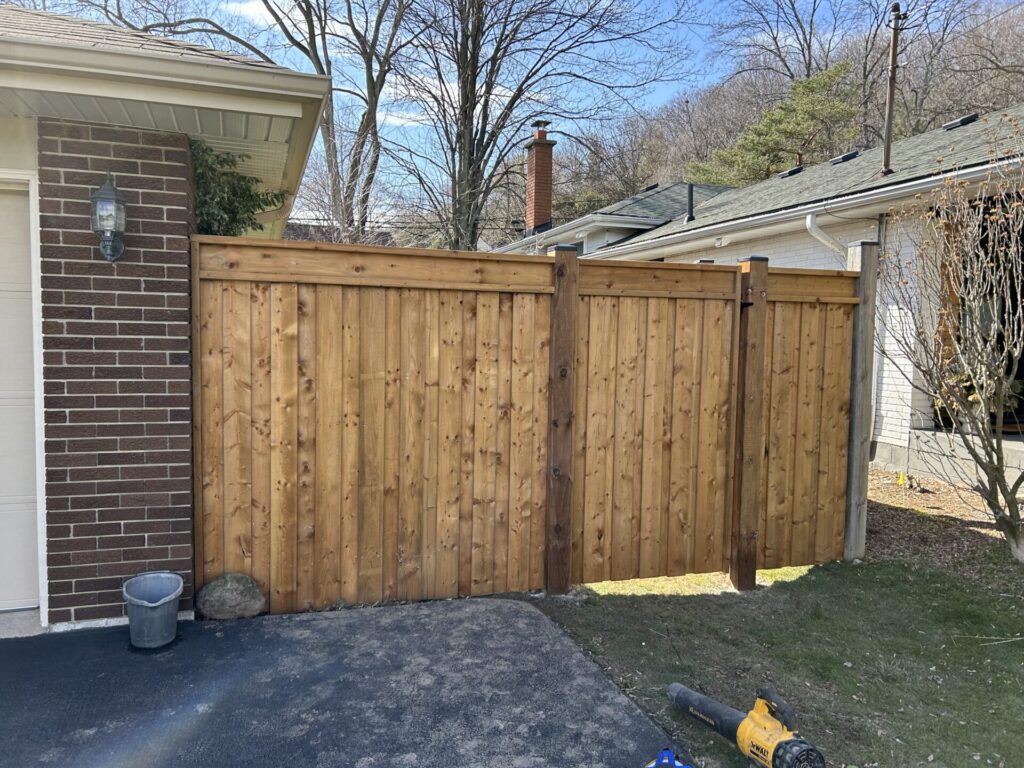 Side yard fence and gate wood privacy fence with post caps and horizontal railing