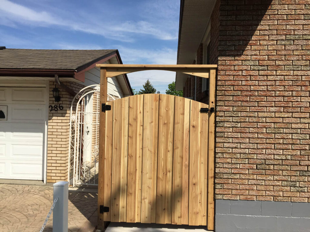 Arched wood gate with arbour