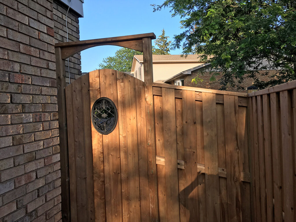 Arched wood gate with arbour and iron insert