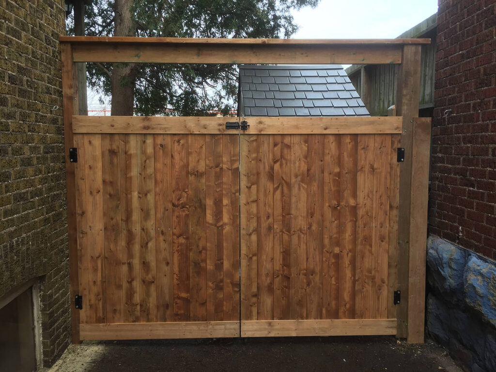 Wood double gate and black hardware with arbour