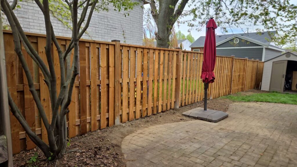 Good neighbour wood fence with post caps and top rail