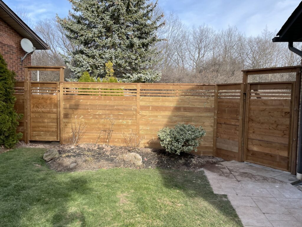 horizontal wood fence with single gates at both ends
