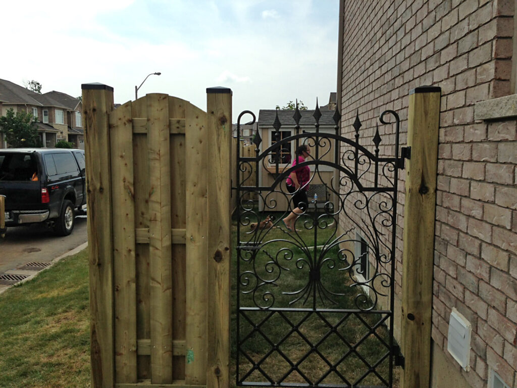 Wrought Iron gate and wood fence