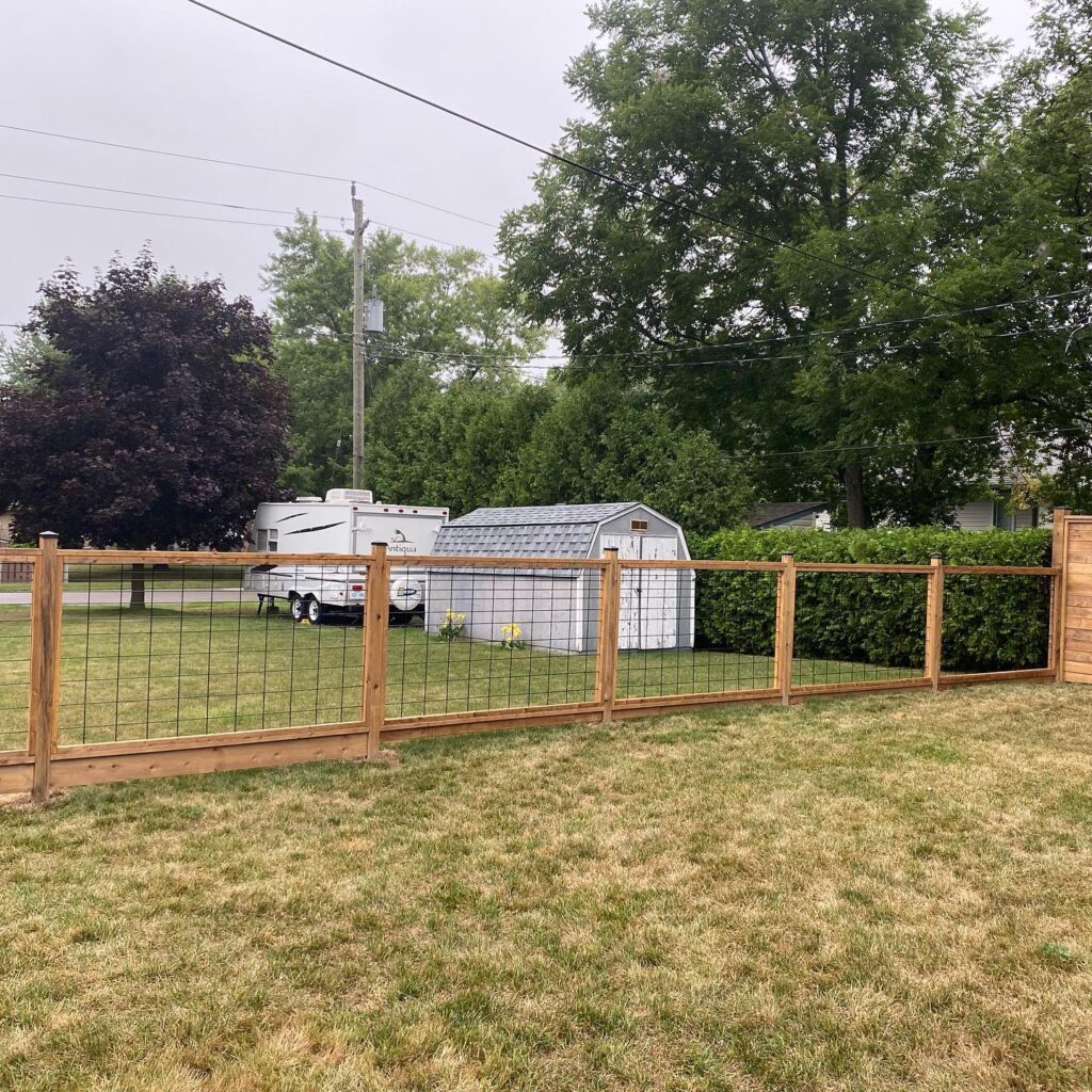 backyard wood and wire fence down the side property