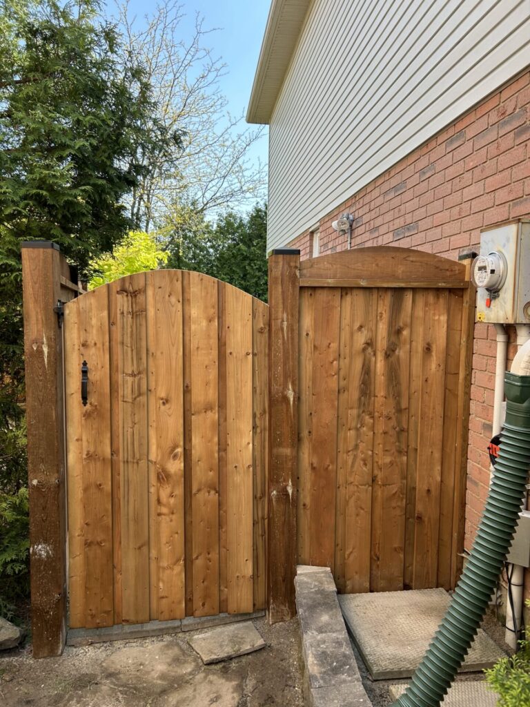 Arched single wood gate and black handle