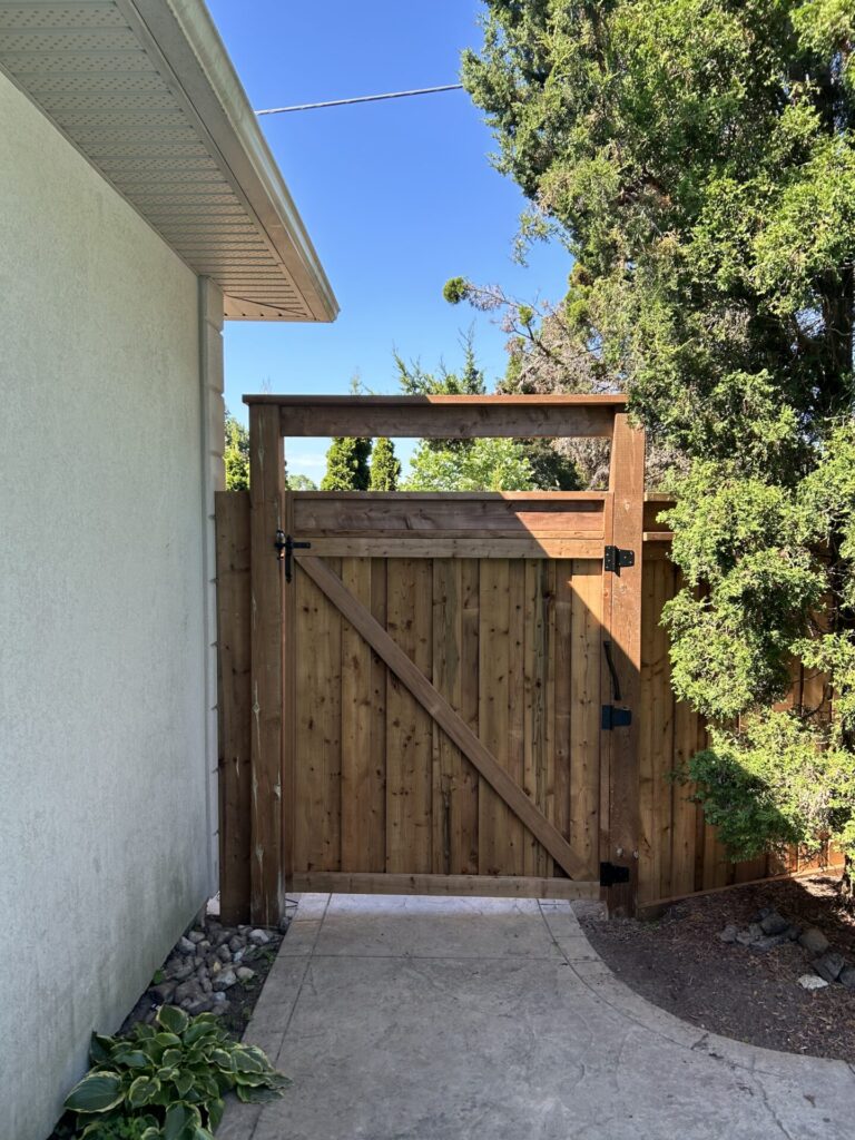 Wood gate with black hardware and arbour