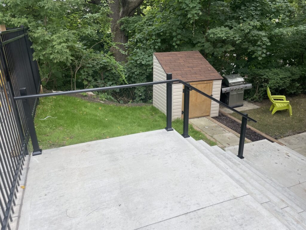 Backyard steps with black aluminum railings