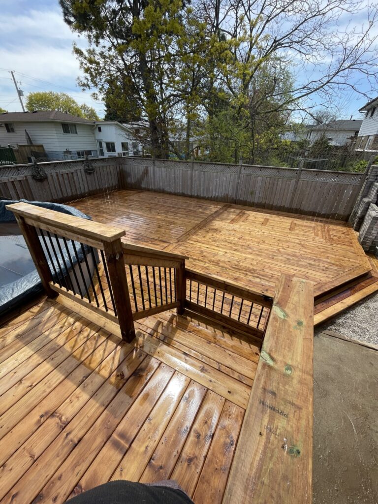 Top view of wood deck with stairs and railings for around an above ground pool